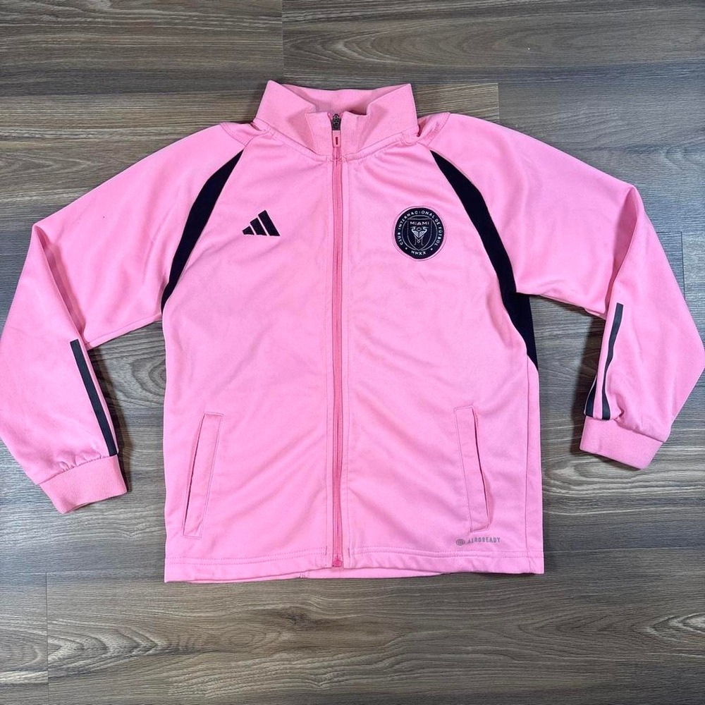 Adidas pink zip-up jacket with black stripes on shoulders and sleeves
